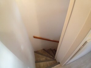 Stairwell with a handrail and door.