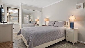 A bedroom with a bed, bedside tables, lamps, a mirror, and a wardrobe. - Wonderful Ocean Block Unit Centrally Located on 70th Street (Ocean City)