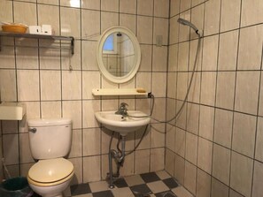 A bathroom with a toilet, sink, mirror, and shower. - Xijing Ecological Farm (Taoyuan City)