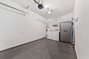 A laundry room with a ceiling fan, a washing machine, and a dryer.