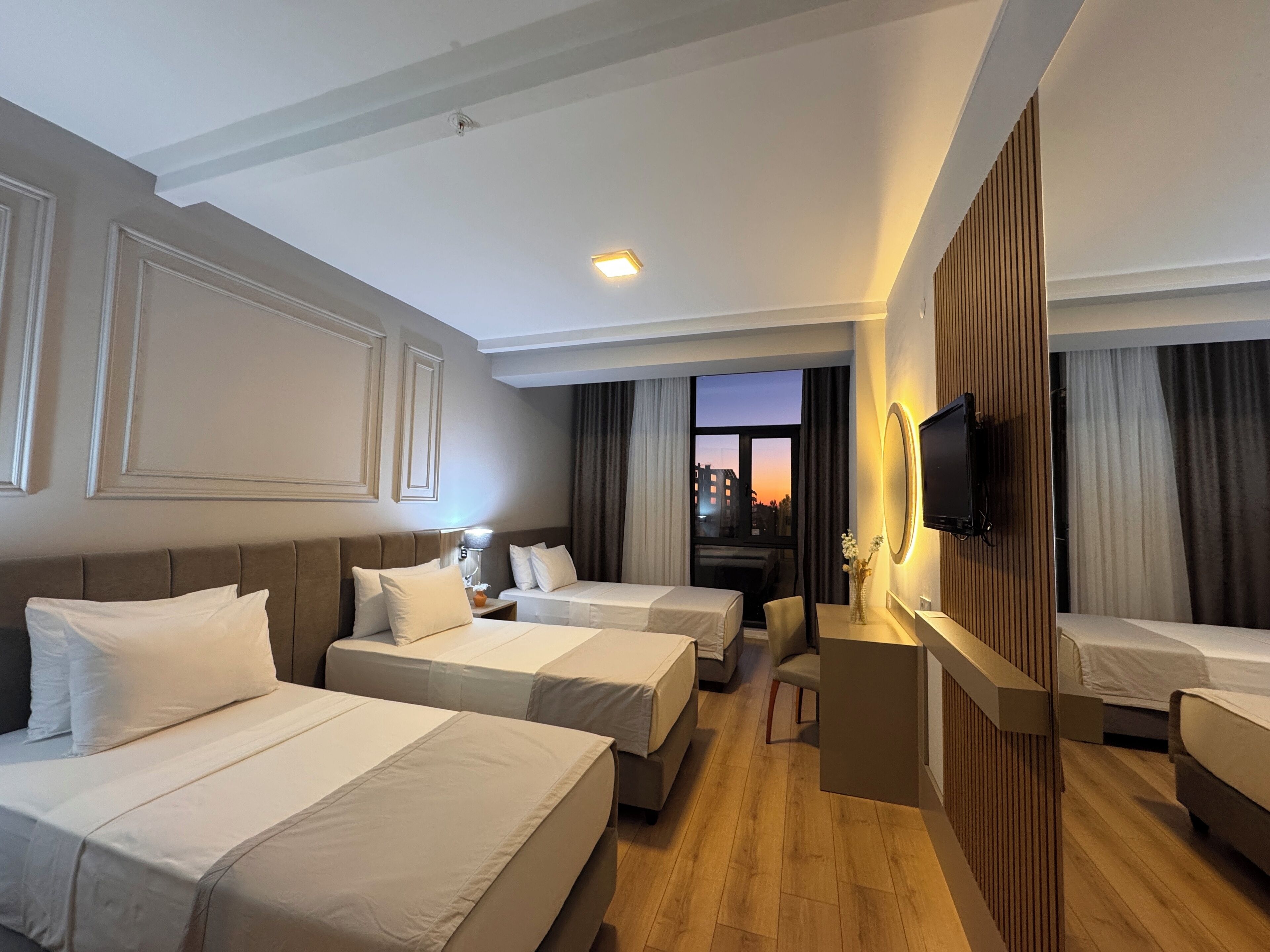 Deluxe Triple Room, 3 Twin Beds, Partial Sea View | Minibar, in-room safe, desk, laptop workspace