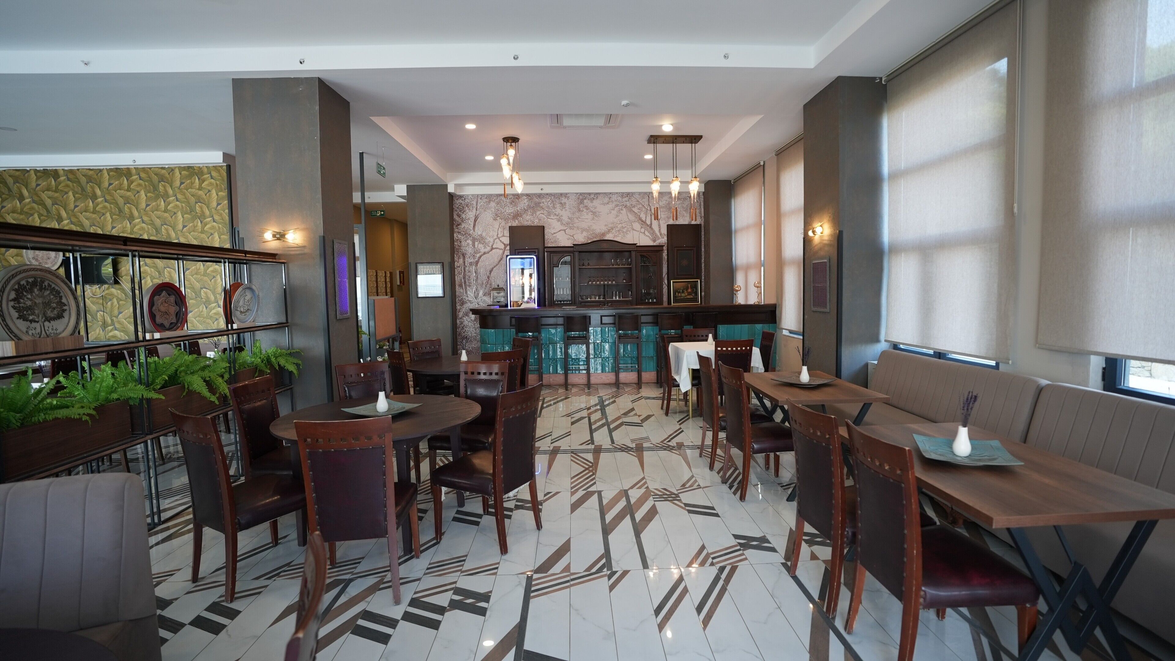 A hotel lobby with a bar area, seating arrangements, and a patterned floor.