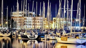 A marina at night with multiple boats docked, reflecting on the water. - Stunning bay views overlooking championship golf course (Lagos)