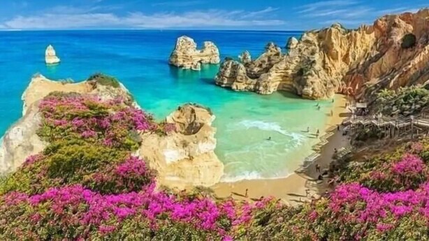 A coastal landscape with rocky formations, clear blue waters, and a beach. - Stunning bay views overlooking championship golf course (Lagos)