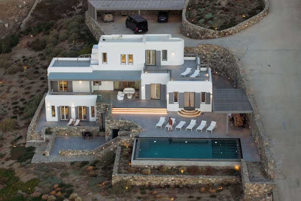 Relax in a spacious outdoor area with a pool, lounge chairs, and garden.