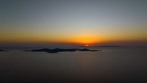 Escape to a serene coastal haven with breathtaking views of the calm sea and distant landforms.