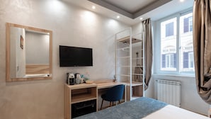 A modern hotel room with a bed, a desk with a chair, a TV, a wardrobe, and a window with curtains. - Leone d'Oro Guesthouse (Rome)