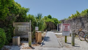 A wooden sign indicating Pelayo Beach Access, a notice sign, and a sign for emergencies with a 911 number. - Hidden Beach Villas 122 - A Sunset Paradise (Santa Rosa Beach)