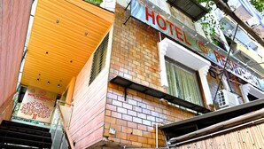 A hotel with a brick facade, a wooden staircase, and a sign that reads "HOTEL RESIDENCY." - Hotel RV Residency (Ahmedabad)