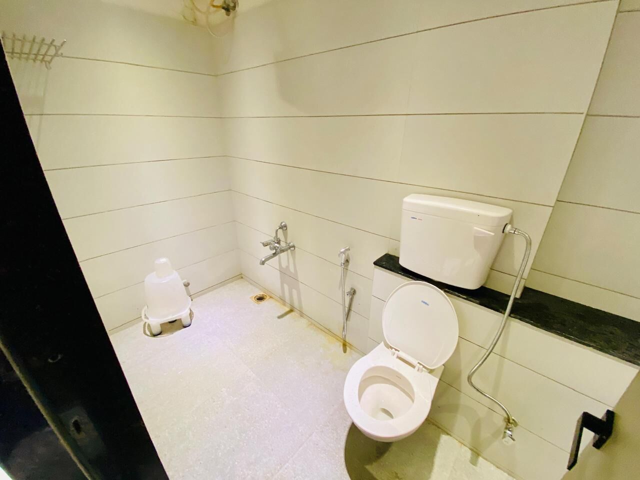 A small, clean bathroom with a toilet, a shower, and a sink.