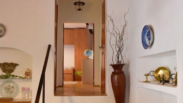 A staircase with a handrail, leading to a room with wooden flooring and a door. - Casa dos Avós - Two Bedroom House, Sleeps 4 (Évora Monte)