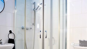 Shower, hair dryer, towels, toilet paper