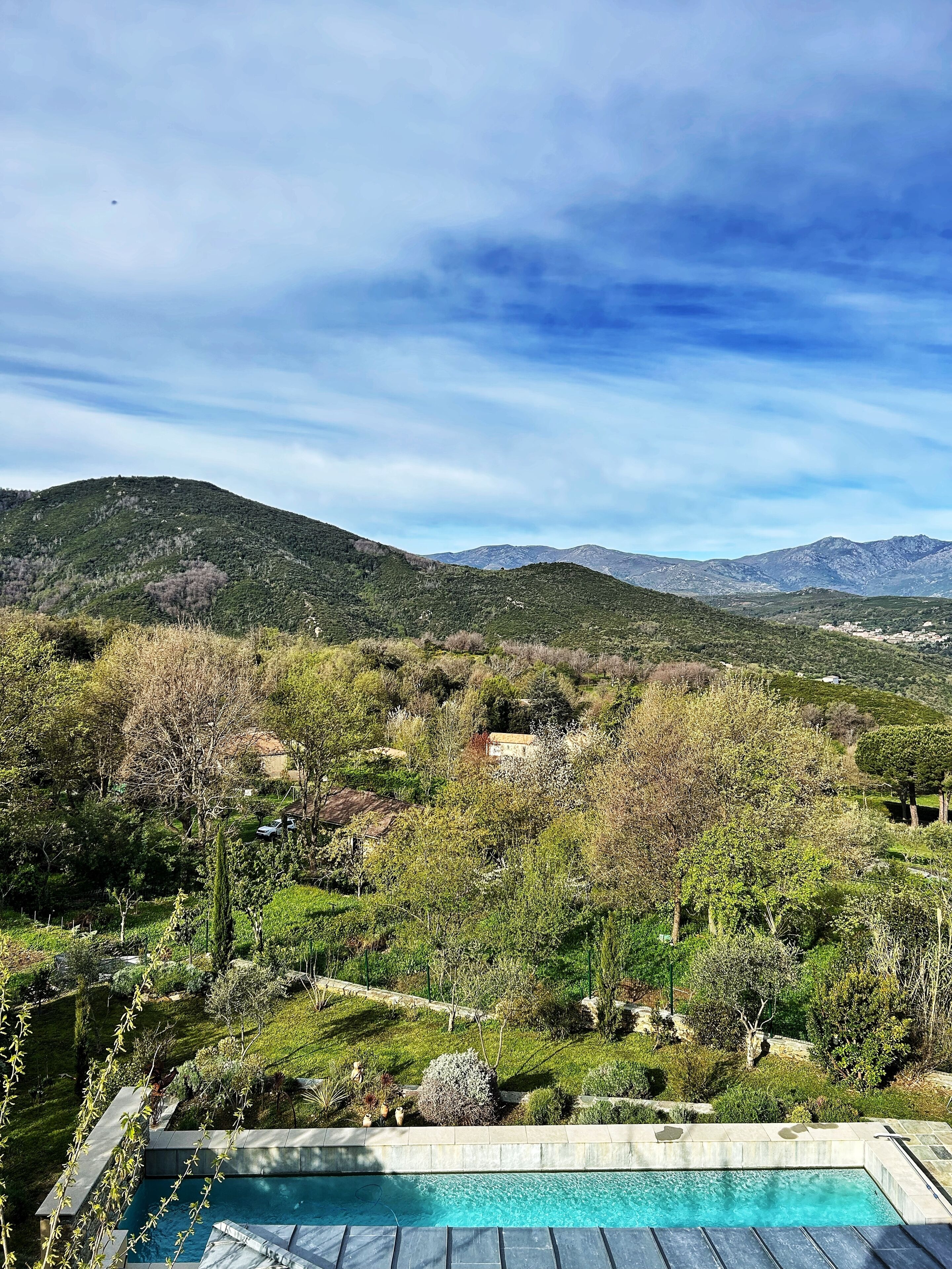 A pool with a view of a mountainous landscape.