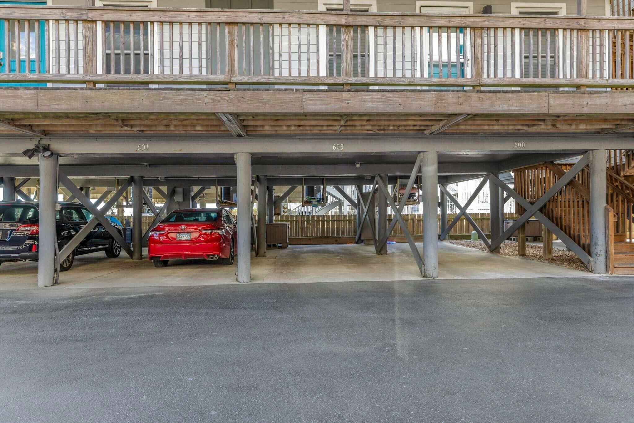 A parking structure with multiple levels and a wooden deck above.