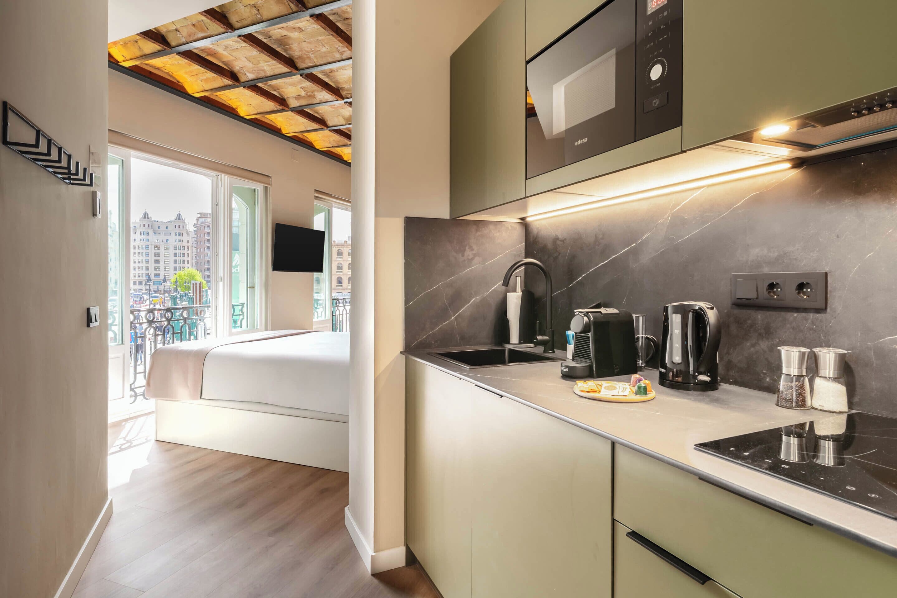 A modern kitchen with a built-in oven, microwave, and a coffee maker.