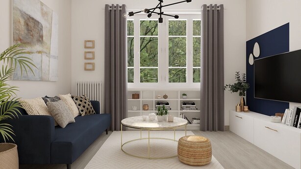 A modern living room with a dark blue sofa, a round coffee table, and a large TV on the wall.