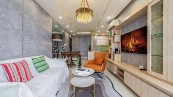 Apartment, City View | Living area | 55-inch LED TV with cable channels
