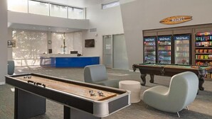 A pool table, a reception desk, and a vending area in a modern lobby. - 2 Bedroom 2 Bath Condo in Oceanside Within Walking Distance to Ocean and Dining (Oceanside)
