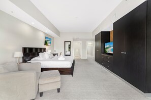 A modern bedroom with a large bed, a sofa, a TV, and a wardrobe. - Two-Level Town House-Doral location-We Host (Miami)