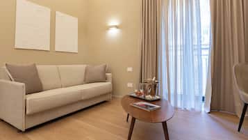 Luxury Suite, City View | Living area | TV