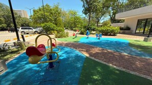A playground with a seesaw, a ball pit, and a slide. - Modern apartment with spectacular ocean views (Santa Marta)