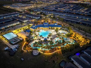 An aerial view of a resort with multiple swimming pools, a tennis court, and a variety of amenities. - 9-bedrooms ~ 25 Mins To Parks ~ Pool, Water Slides Hot Tub, Sauna, Mini Golf! (Davenport)
