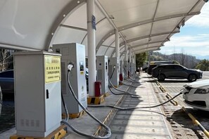 A row of fuel pumps under a covered area with cars parked nearby. - Lexinghua Juzhusu (Taizhou Tiantai Guoqing Scenic Area Branch) (Tiantai County)