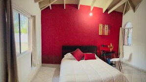 A bedroom with a large bed, a desk, and a chair. - San Quintín Casa Skov (San Quintín)