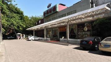A building with a covered entrance and a signboard.