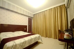 A hotel room with a bed, a desk with a chair, a TV, and curtains. - City 118 Hotel (High-speed) (Gaoyi)