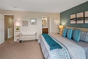A bedroom with a bed, bedside tables, a bench, a mirror, and artwork on the walls. - Myrinn – Sunset Deck with Panoramic Red Rock Views (Sedona)