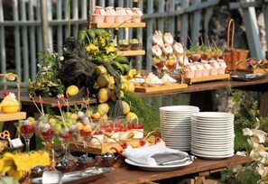 A buffet table with various food items and drinks, including fruits, desserts, and beverages. - Holiday Inn WUHAN RIVERSIDE by IHG (Wuhan)