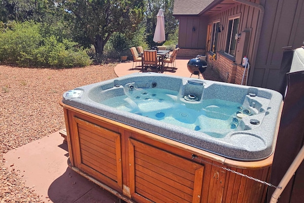 Relax in the outdoor hot tub, nestled in the backyard patio.