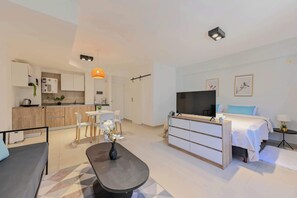 Relax in a spacious living area with a sofa, dining table, and oven.