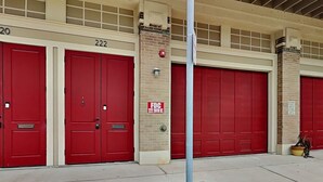 A fire station with red doors and a brick exterior. - Charming 2-bedroom condo located on the Historic Strand with WiFi, AC (Galveston)