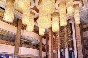 A grand interior with ornate chandeliers, a high ceiling, and a luxurious design. - Rui'er Hotel (Chongqing)