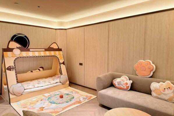 A child’s bunk bed with a cartoon design, a sofa with animal-themed cushions, and a patterned rug. - Crystal Orange Changsha IFS (Changsha)