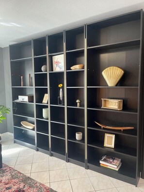 Storage unit with open shelves, closed compartments, and a flat surface.
