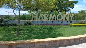 A sign for Harmony Beach Park with a landscaped area in front. - Blue Seas Two Unity Hall (Montego Bay)