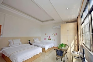 A bedroom with two beds, a small table with a plant, a chair, and a window with a view. - Huangyao Xinyi Inn (Zhaoping)