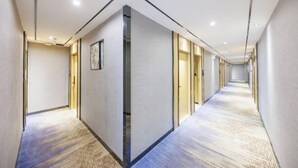 A long, narrow hotel corridor with a patterned carpet, recessed lighting, and a modern design. - chengfeng hotel(jianggao dian) (Guangzhou)