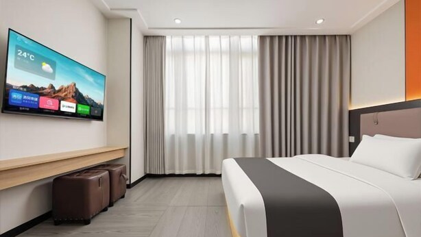 A modern hotel room with a bed, a TV displaying weather, a window with curtains, and a wooden bench. - chengfeng hotel(jianggao dian) (Guangzhou)