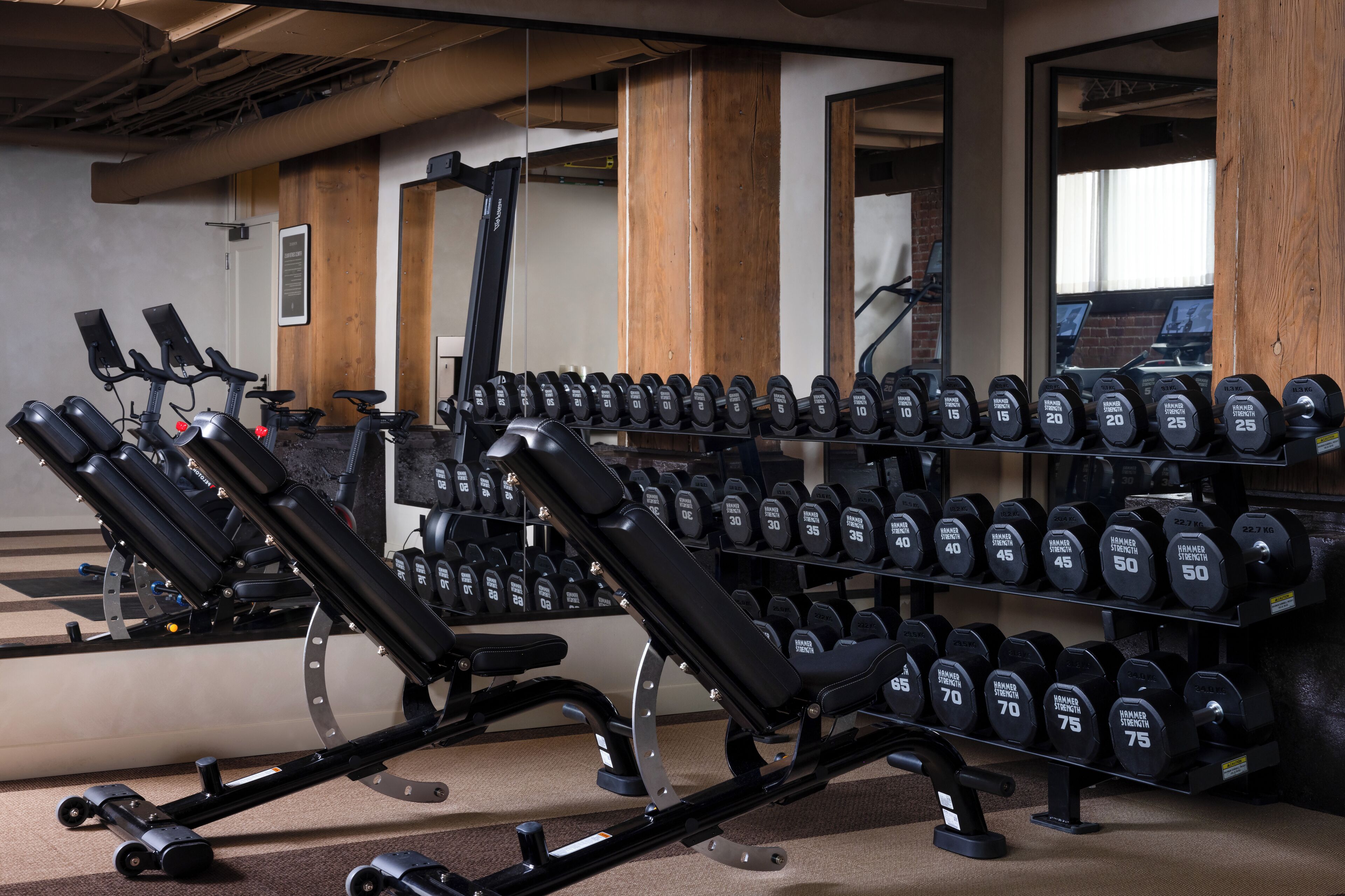 A gym with exercise equipment, including treadmills and dumbbells.