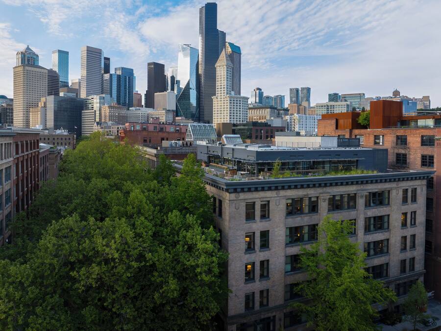 A cityscape with modern high-rise buildings and a mix of older brick structures.