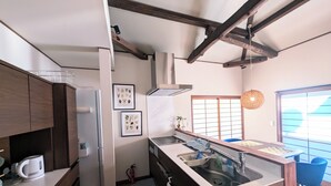 A modern kitchen with a built-in dishwasher, a sink, and a window with a view.