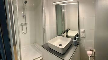 Shower, hair dryer, towels, toilet paper