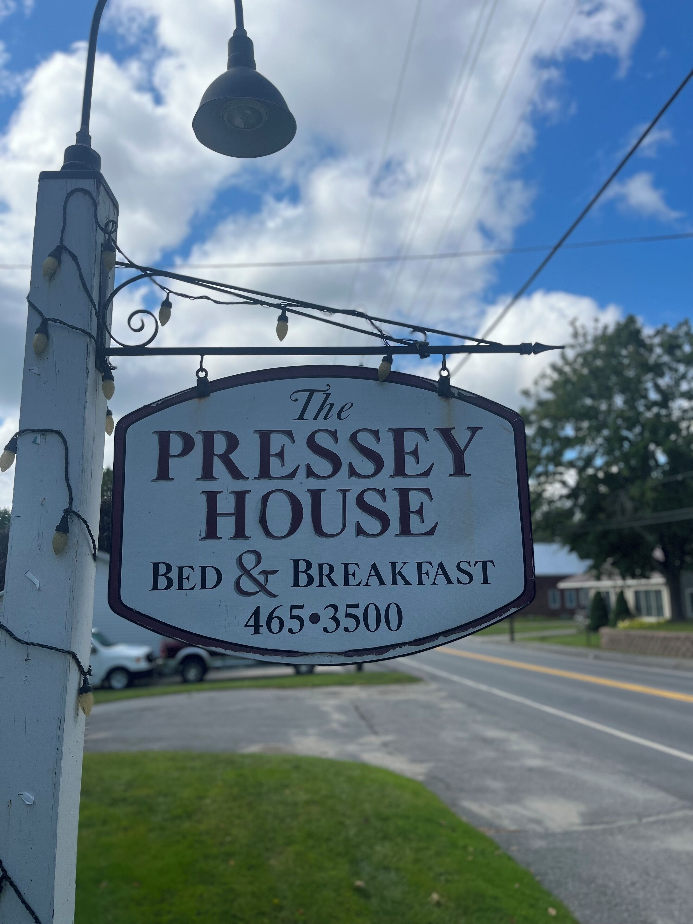 A sign for The Pressey House Bed & Breakfast with a contact number.