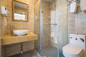 A bathroom with a glass-enclosed shower, a sink with a mirror, and a toilet. - Jinzi Business Hotel (Shanghai)