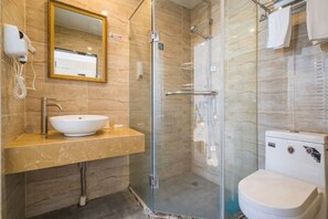 A bathroom with a glass-enclosed shower, a sink with a mirror, and a toilet. - Jinzi Business Hotel (Shanghai)