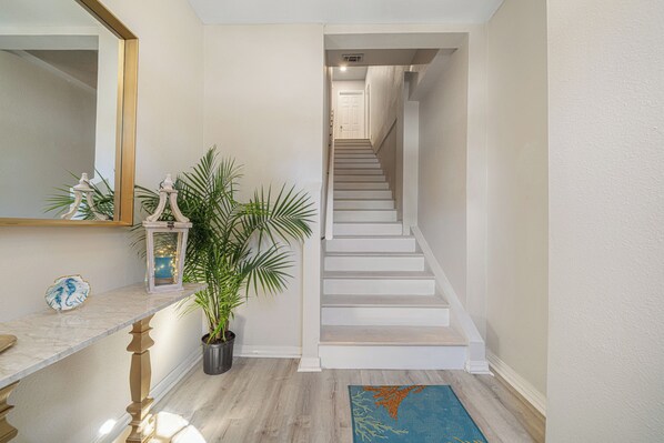 A staircase with white steps and a handrail, leading to a door at the top. - Walk to Navarre Beach - Stylish Coastal Retreat w/ Beach Gear + Pet Friendly (Navarre)